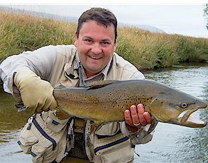 Spring Creek Brown Trout held up by a happy client