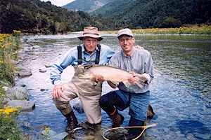 Clients with a stocky Brown Trout from a bush clad wilderness river